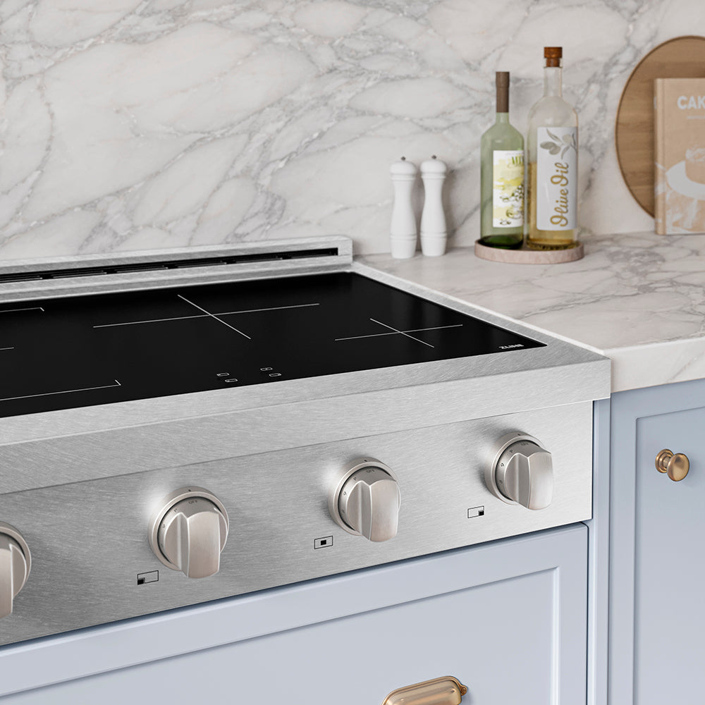 ZLINE 30 in. Paramount Induction Rangetop with 4 Element Cooktop in Satin Stainless Steel (SINRTS-30) in a designer kitchen with marble backsplash, light blue cabinets, angled.
