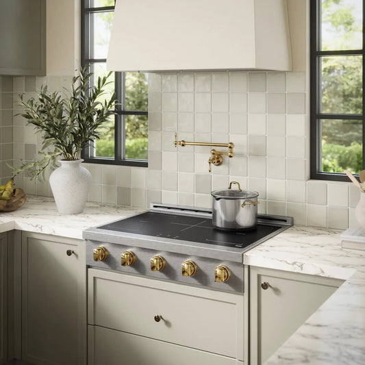 Modern kitchen with a ZLINE Autograph Edition 36 in. Paramount Induction Rangetop with 5 Element Cooktop in Satin Stainless Steel and Polished Gold Accents (SINRTSZ-36-G), pots, and decorative elements.