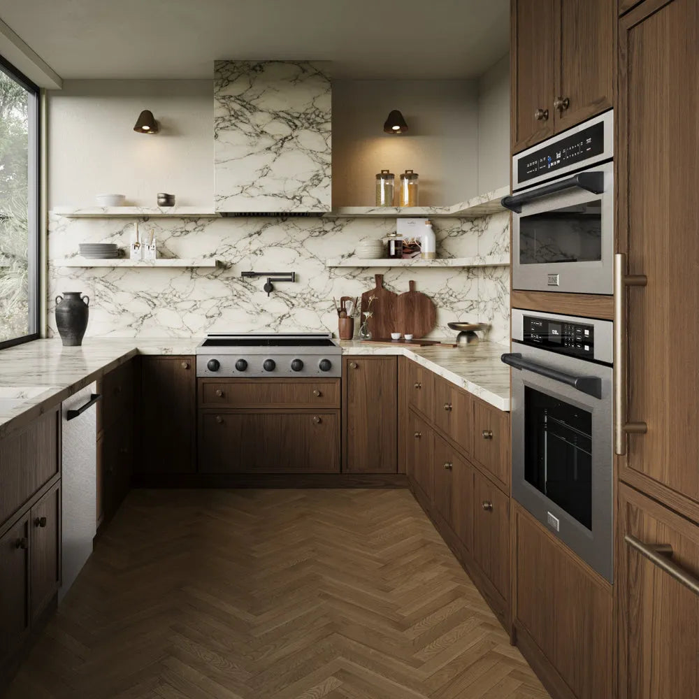 A modern kitchen interior with dark wood cabinetry, marble countertops and backsplash, a herringbone wood floor, ZLINE Autograph Edition 36 in. Paramount Induction Rangetop with 5 Element Cooktop in Satin Stainless Steel and Matte Black Accents (SINRTSZ-36-MB), and open shelving with decorative items.