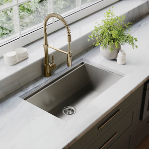 ZLINE Sierra Pull Down Spring Single Handle Kitchen Faucet in Champagne Bronze (SRA-KF-CB) above a kitchen sink with marble countertop