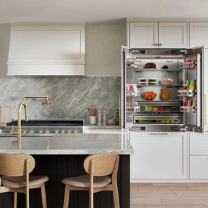 ZLINE 36 in. 19.6 cu. ft. Panel Ready French Door Built-In Bottom Freezer Refrigerator with Water Dispenser and Ice Maker with Stainless Steel Interior (SRBIV-36) open with food inside and with custom white panels in a luxury kitchen.