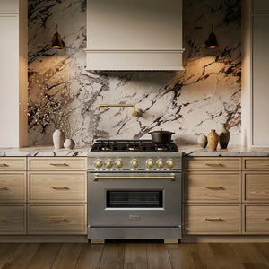 ZLINE Autograph Edition 36 in. 5.2 cu. ft. Classic Dual Fuel Range with 6 Burner DuoPro™ Cooktop and Electric Convection Oven in Satin Stainless Steel and Champagne Bronze Accents (PCDRSZ-36-CB) in a custom kitchen against a marble backsplash, front.