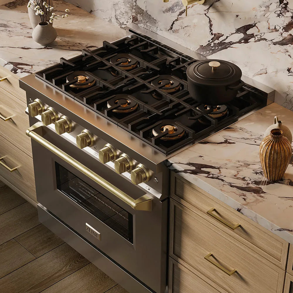 ZLINE Autograph Edition 36 in. 5.2 cu. ft. Classic Dual Fuel Range with 6 Burner DuoPro™ Cooktop and Electric Convection Oven in Stainless Steel and Champagne Bronze Accents (PCDRZ-36-CB) in a custom kitchen against a marble backsplash, side, above cooktop.