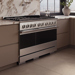 ZLINE 48 in. 6.7 cu. ft. Marino Double Oven Dual Fuel Range in Stainless Steel with 8 Brass Burners (MDR-BR-48) side, set in a modern kitchen with beige cabinets and a marble backsplash.