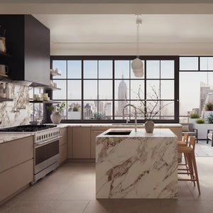 ZLINE 48 in. 6.7 cu. ft. Marino Double Oven Dual Fuel Range with 8 Burner Gas Cooktop in Satin Stainless Steel (MDRS-48) front, set in a modern kitchen with beige cabinets, a large marble island, dark cabinetry, and expansive windows overlooking a city skyline.