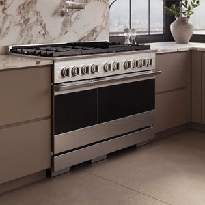 ZLINE 48 in. 6.7 cu. ft. Marino Double Oven Dual Fuel Range with 8 Burner Gas Cooktop in Satin Stainless Steel (MDRS-48) side, set in a modern kitchen with beige cabinets and a marble backsplash.