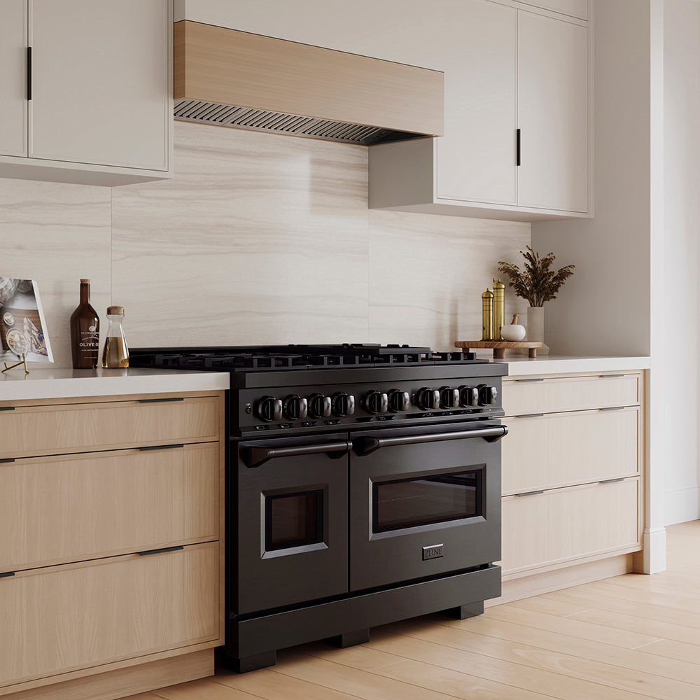 ZLINE 48 in. 6.7 cu. ft. Classic Dual Fuel Range with 8 Burner DuoPro™ Cooktop and Dual Ovens in Black Stainless Steel (PCDRB-48) in a custom kitchen with wooden cabinets and white walls, side.