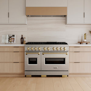 ZLINE Autograph Edition 48 in. 6.7 cu. ft. Classic Dual Fuel Range with 8 Burner DuoPro™ Cooktop and Dual Ovens in Satin Stainless Steel and Champagne Bronze Accents (PCDRSZ-48-CB) in a custom kitchen with wooden cabinets and white walls, front.