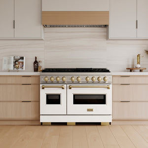 ZLINE Autograph Edition 48 in. 6.7 cu. ft. Classic Dual Fuel Range with 8 Burner DuoPro™ Cooktop and Dual Ovens with White Matte Doors and Champagne Bronze Accents (PCDRZ-WM-48-CB) in a custom kitchen with wooden cabinets and white walls, front.