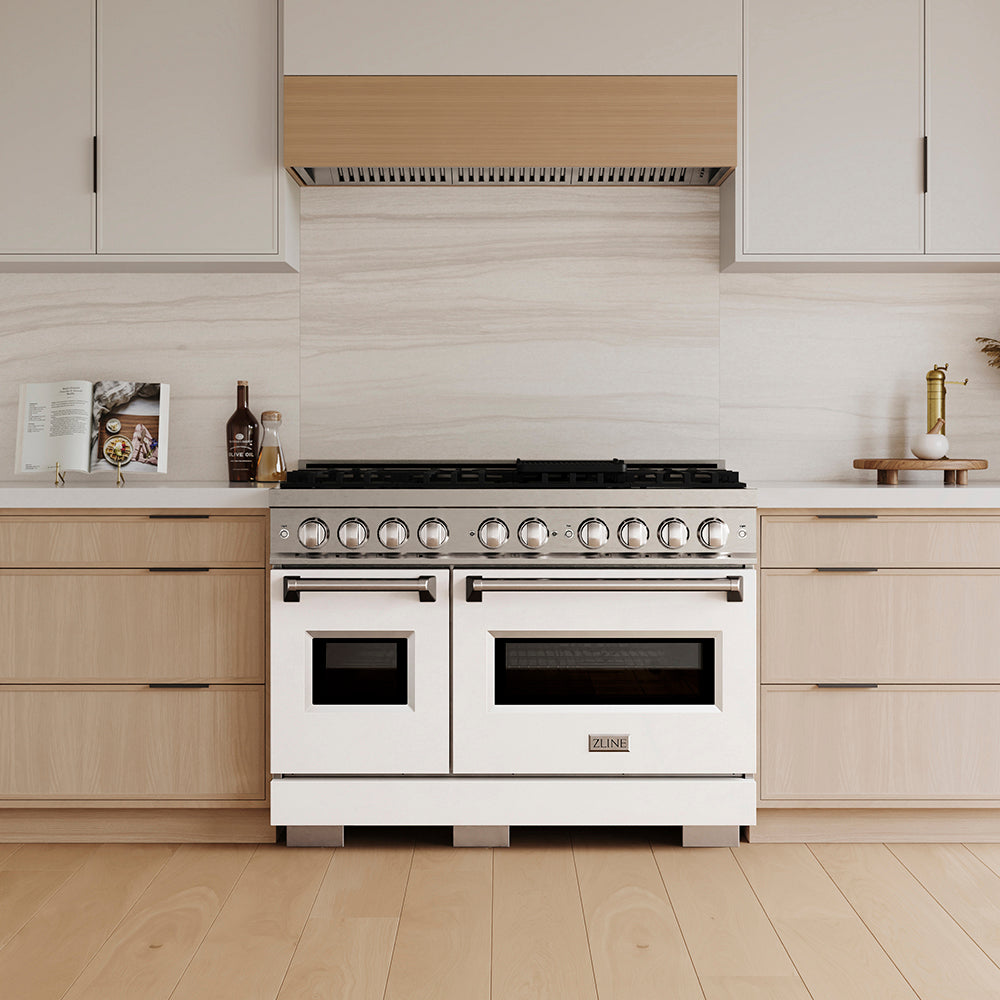 ZLINE 48 in. 6.7 cu. ft. Classic Gas Range with 8 Burner DuoPro™ Cooktop and Dual Ovens with White Matte Doors (PCGR-WM-48) in a custom kitchen with wooden cabinets and white walls, front.