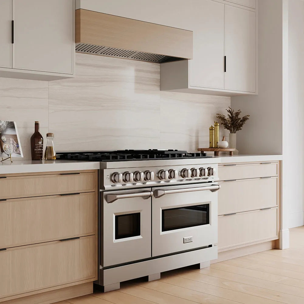 ZLINE 48 in. 6.7 cu. ft. Classic Gas Range with 8 Burner DuoPro™ Cooktop and Dual Ovens in Stainless Steel (PCGR48) in a custom kitchen with wooden cabinets and white walls, side.