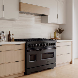 ZLINE 48 in. 6.7 cu. ft. Classic Gas Range with 8 Burner DuoPro™ Cooktop and Dual Ovens in Black Stainless Steel (PCGRB-48) in a custom kitchen with wooden cabinets and white walls, side.