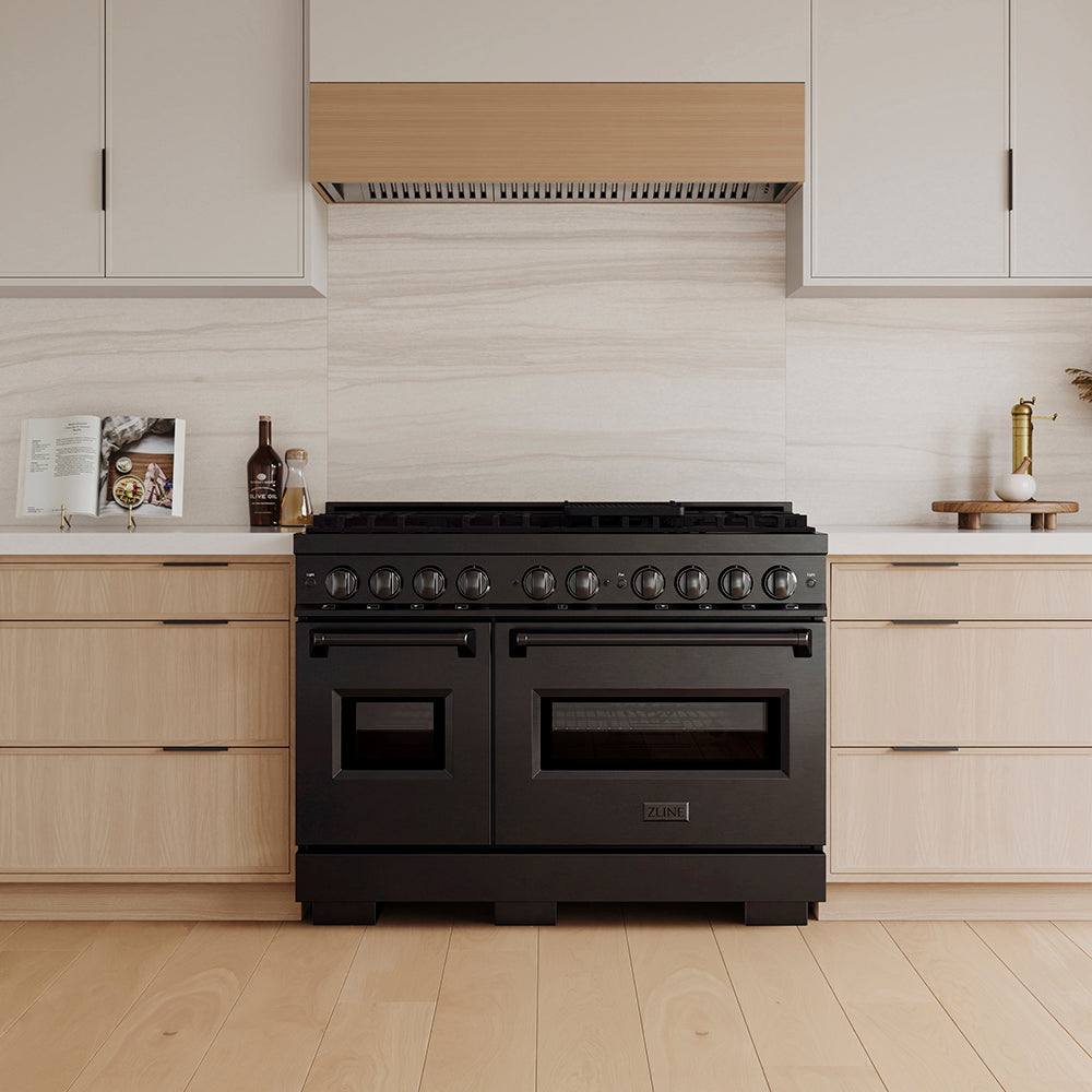 ZLINE 48 in. 6.7 cu. ft. Classic Gas Range with 8 Burner DuoPro™ Cooktop and Dual Ovens in Black Stainless Steel (PCGRB-48) in a custom kitchen with wooden cabinets and white walls, front.