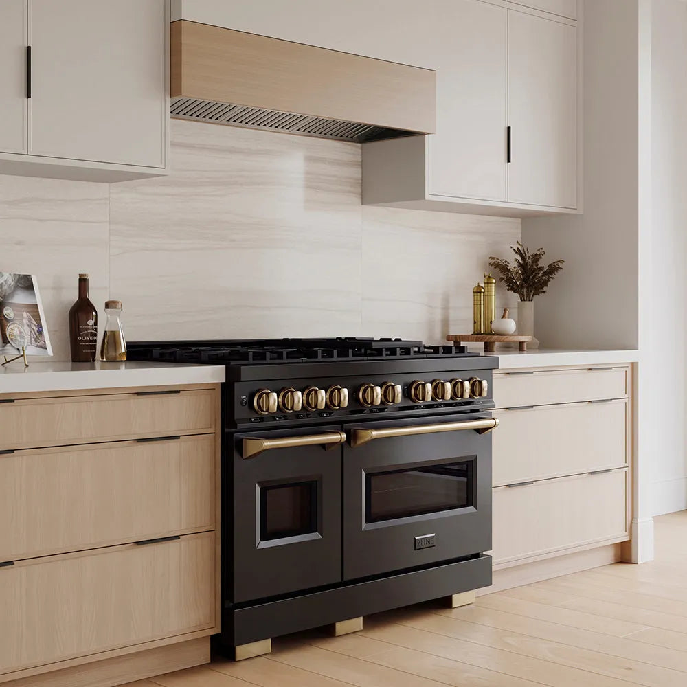 ZLINE Autograph Edition 48 in. 6.7 cu. ft. Classic Gas Range with 8 Burner DuoPro™ Cooktop and Dual Ovens in Black Stainless Steel and Champagne Bronze Accents (PCGRBZ-48-CB) in a custom kitchen with wooden cabinets and white walls, side.