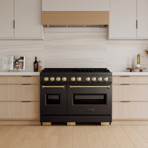 ZLINE Autograph Edition 48 in. 6.7 cu. ft. Classic Gas Range with 8 Burner DuoPro™ Cooktop and Dual Ovens in Black Stainless Steel and Champagne Bronze Accents (PCGRBZ-48-CB) in a custom kitchen with wooden cabinets and white walls, front.