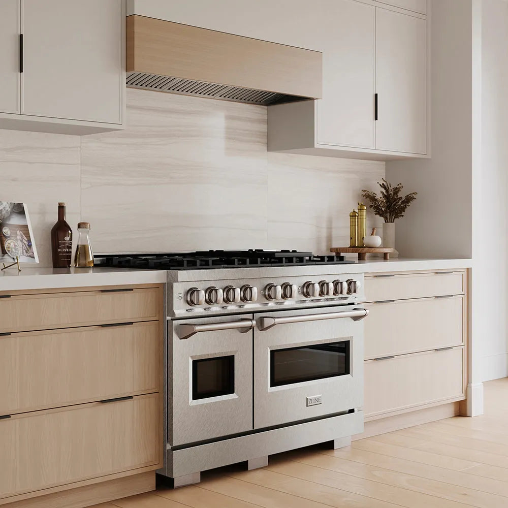 ZLINE 48 in. 6.7 cu. ft. Classic Gas Range with 8 Burner DuoPro™ Cooktop and Dual Ovens in Satin Stainless Steel (PCGRS-48) in a custom kitchen with wooden cabinets and white walls, side.
