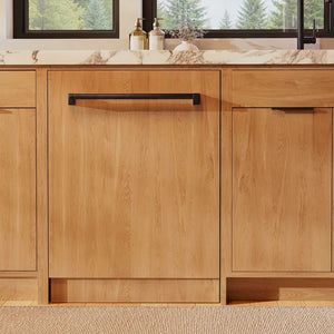 ZLINE Autograph Edition 24 in. Monument Series 3rd Rack Dishwasher with Auto Door Open Drying, 44dBa, Panel Ready with Matte Black Handle (DWMTZ-24-MB) front, in a kitchen with wooden cabinets and a window view.