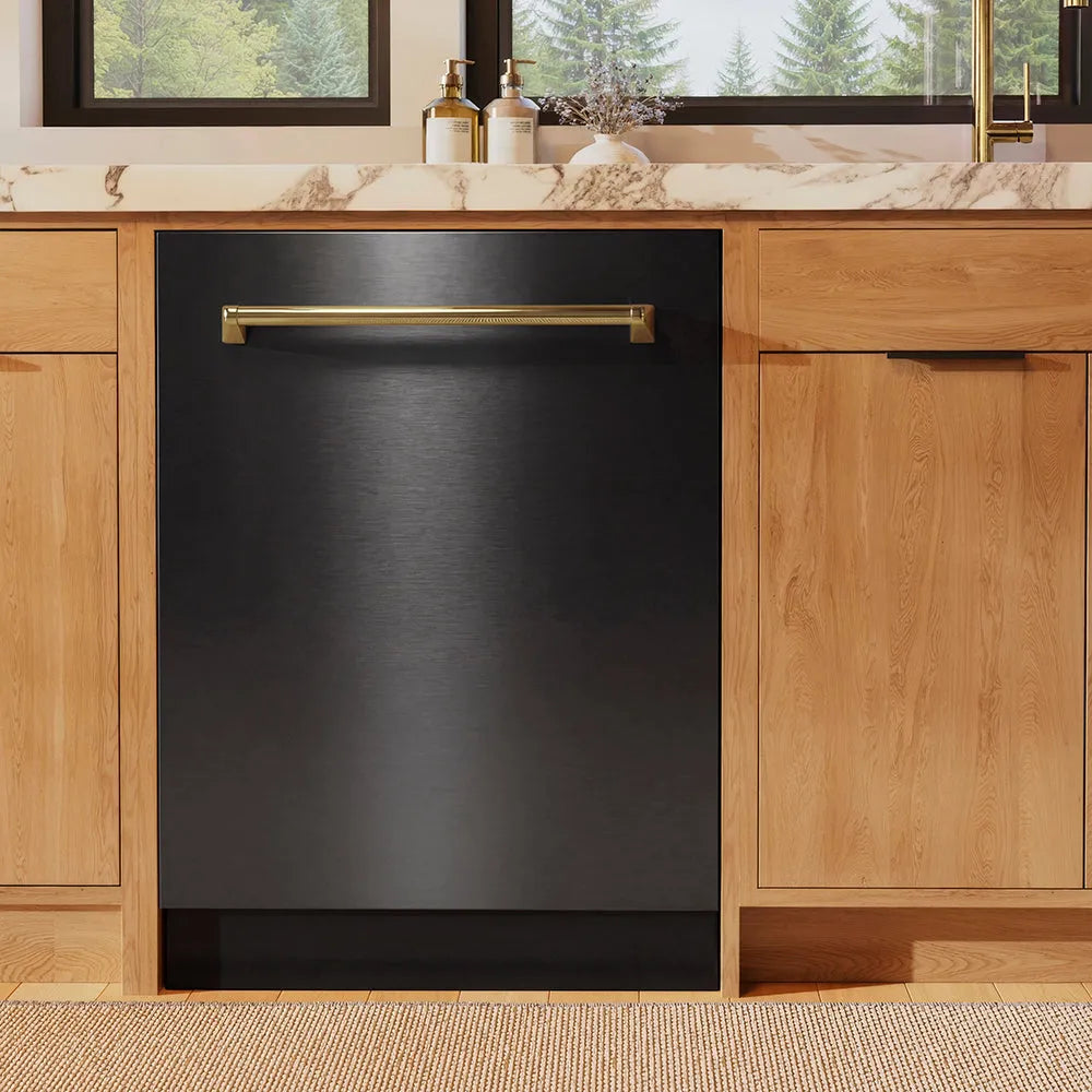 ZLINE Autograph Edition 24 in. Monument Series 3rd Rack Dishwasher with Auto Door Open Drying, 44dBa, Black Stainless Steel Panel with Polished Gold Handle (DWMTZ-BS-24-G) front, in a kitchen with wooden cabinets and a window view.