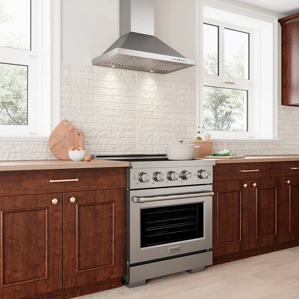 ZLINE 30 in. Convertible Vent Wall Mount Range Hood in Stainless Steel (KB-30) in a modern kitchen with a stainless steel range and wooden cabinets.