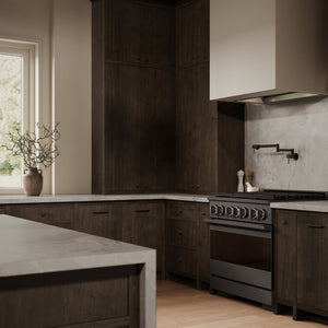 ZLINE 36 in. 5.2 cu. ft. Marino Gas Range with Convection Gas Oven in Black Stainless Steel with 6 Brass Burners (MGRB-BR-36) side, in a modern kitchen with dark wood cabinetry, light stone countertops, a large white range hood, and a window on the left.