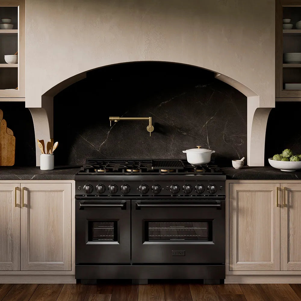 ZLINE 48 in. 6.7 cu. ft. Classic Dual Fuel Range with 8 Burner DuoPro™ Cooktop and Dual Ovens in Black Stainless Steel (PCDRB-48) in a custom kitchen with marble backsplash and large range hood, front.