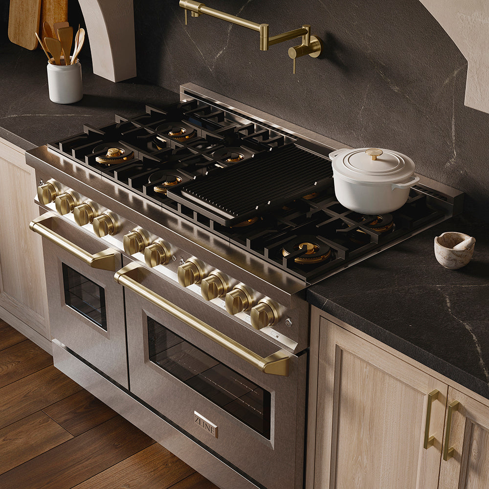 ZLINE Autograph Edition 48 in. 6.7 cu. ft. Classic Dual Fuel Range with 8 Burner DuoPro™ Cooktop and Dual Ovens in Satin Stainless Steel and Champagne Bronze Accents (PCDRSZ-48-CB) in a custom kitchen with marble backsplash and large range hood, side, above cooktop.