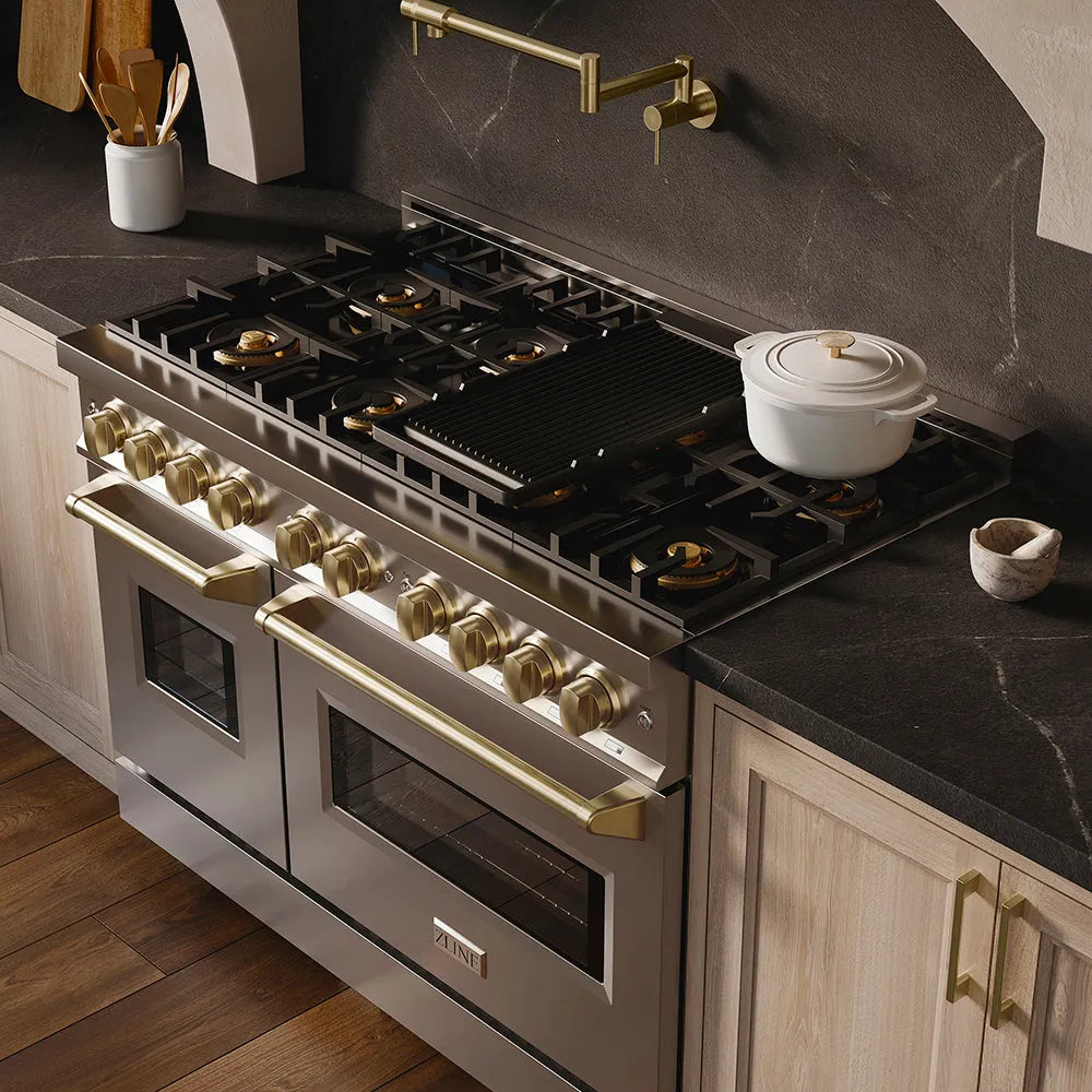 ZLINE Autograph Edition 48 in. 6.7 cu. ft. Classic Dual Fuel Range with 8 Burner DuoPro™ Cooktop and Dual Ovens in Stainless Steel and Champagne Bronze Accents (PCDRZ-48-CB) in a custom kitchen with marble backsplash and large range hood, side, above cooktop.