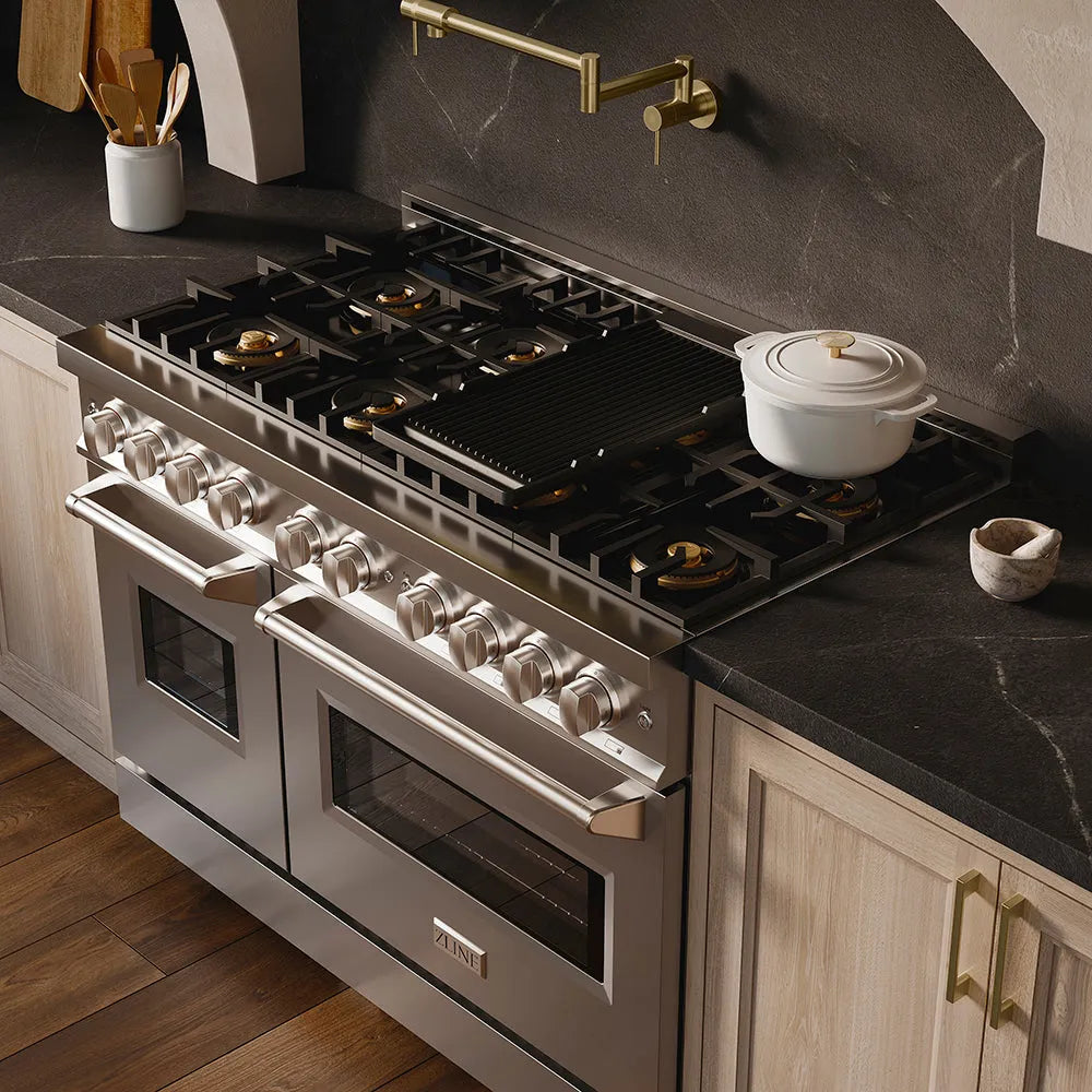ZLINE 48 in. 6.7 cu. ft. Classic Gas Range with 8 Burner DuoPro™ Cooktop and Dual Ovens in Stainless Steel (PCGR48) in a custom kitchen with marble backsplash and large range hood, side, above cooktop.
