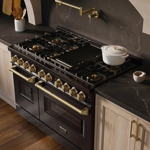 ZLINE Autograph Edition 48 in. 6.7 cu. ft. Classic Gas Range with 8 Burner DuoPro™ Cooktop and Dual Ovens in Black Stainless Steel and Champagne Bronze Accents (PCGRBZ-48-CB) in a custom kitchen with marble backsplash and large range hood, side, above cooktop.