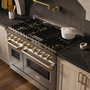 ZLINE Autograph Edition 48 in. 6.7 cu. ft. Classic Gas Range with 8 Burner DuoPro™ Cooktop and Dual Ovens in Satin Stainless Steel and Champagne Bronze Accents (PCGRSZ-48-CB) in a custom kitchen with marble backsplash and large range hood, side, above cooktop.