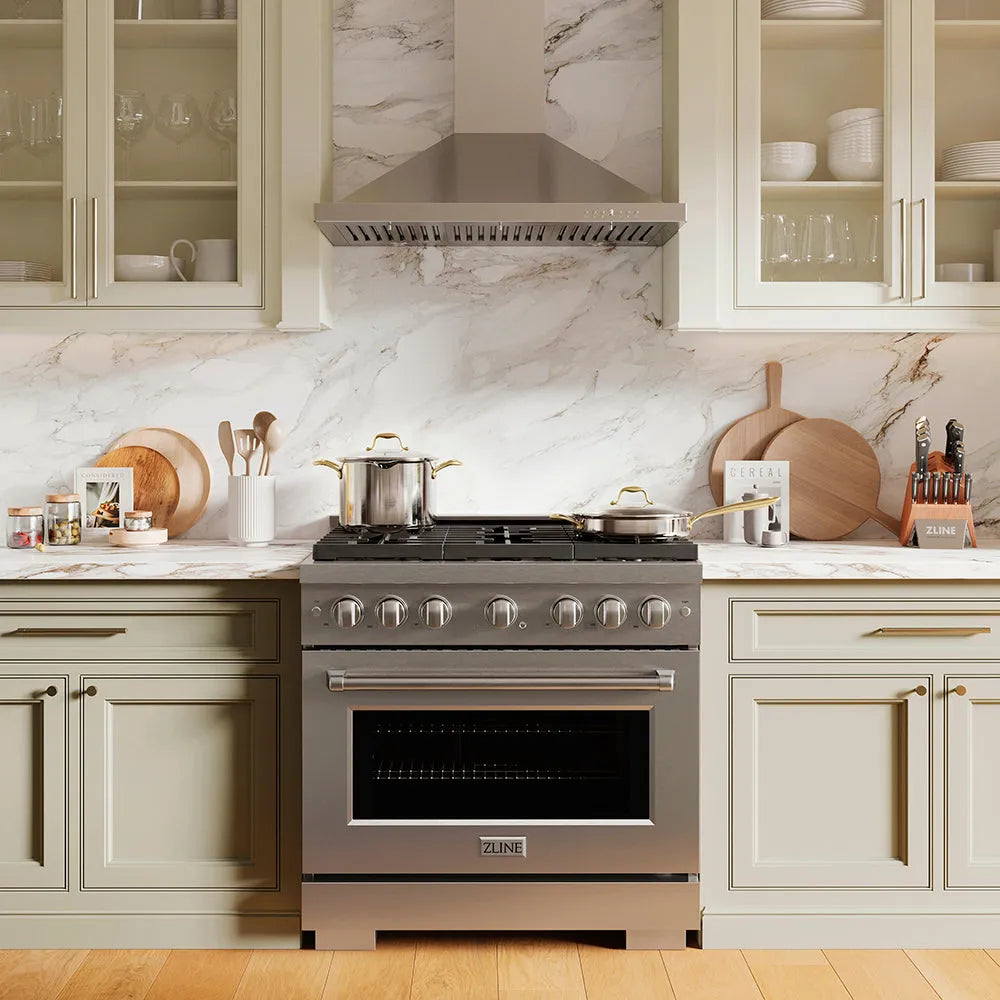 ZLINE 36 in. Convertible Vent Wall Mount Range Hood in Stainless Steel (KB-36) above stainless steel range in a luxury kitchen with marble backsplash and wooden floors.