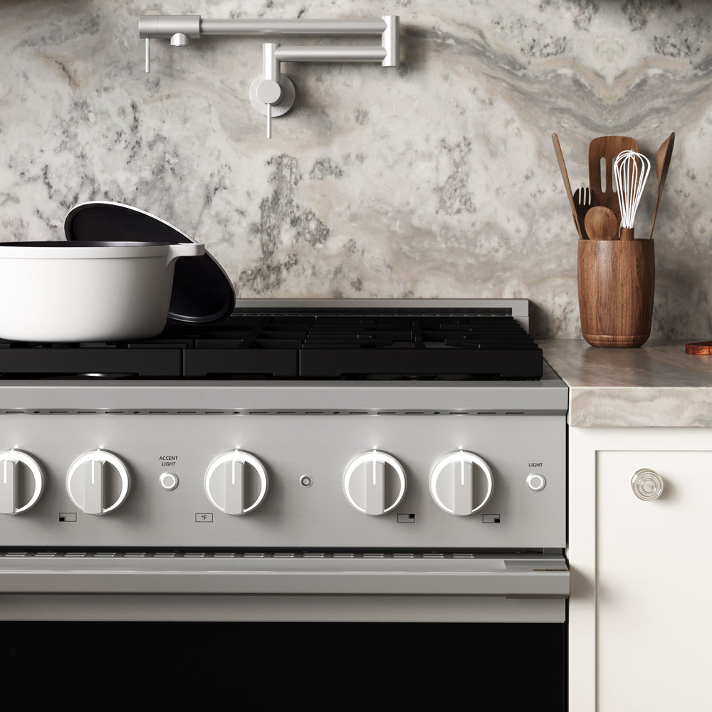 ZLINE 30 in. 4.2 cu. ft. Marino Gas Range with 4 Burner Cooktop and Convection Gas Oven in Stainless Steel (MGR30) front close-up, set in a modern kitchen with marble countertops. A white pot sits on the cooktop, and a wooden utensil holder is on the counter.