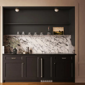 ZLINE 15 in. Touchstone Nugget Ice Maker with Drain Pump and Panel-Ready Door (INGDP-15) in a modern built-in bar cabinet, styled with glassware, a vase of flowers, and a small framed picture.