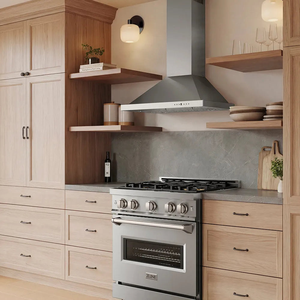 A ZLINE 30 in. Convertible Vent Wall Mount Range Hood in Stainless Steel (KB-30) in a modern kitchen setting, integrated into a cabinetry layout with light wood drawers and open shelves.
