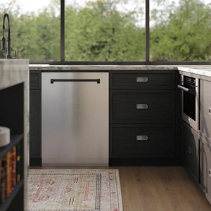 ZLINE Autograph Edition 24 in. Monument Series 3rd Rack Dishwasher with Auto Door Open Drying, 44dBa, Stainless Steel Panel with Matte Black Handle (DWMTZ-304-24-MB) front, in a modern kitchen with black cabinets, stainless steel appliances, and a window view of greenery.