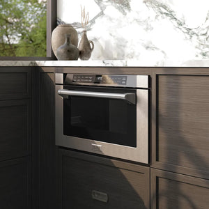 ZLINE 24 in. 1.2 cu. ft. Built-in Microwave Drawer with a Traditional Handle in Stainless Steel (MWD-1-H) embedded in wooden kitchen cabinets with a window view.