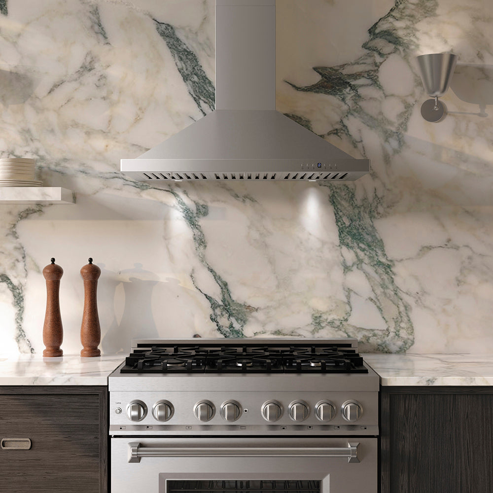Luxury kitchen with ZLINE 36 in. Convertible Vent Wall Mount Range Hood in Stainless Steel (KB-36), stainless steel stove, and marble backsplash