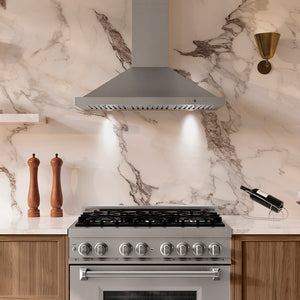 Modern kitchen with ZLINE 36 in. Convertible Vent Wall Mount Range Hood in Stainless Steel (KB-36) and stove against a marble backsplash.