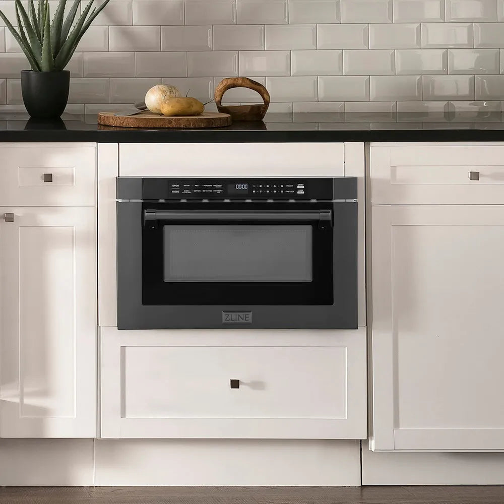 ZLINE 24 in. 1.2 cu. ft. Built-in Microwave Drawer with a Traditional Handle in Black Stainless Steel (MWD-1-BS-H) embedded in white kitchen cabinetry with a tiled backsplash.