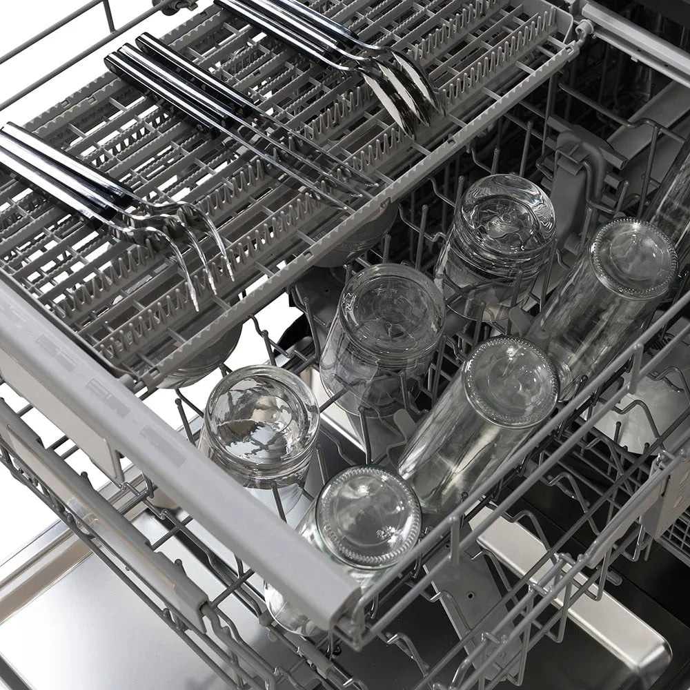 ZLINE Autograph Edition 24 in. Monument Series 3rd Rack Dishwasher with Auto Door Open Drying, 44dBa, Stainless Steel Panel with Polished Gold Handle (DWMTZ-304-24-G) with glass jars and utensils inside.
