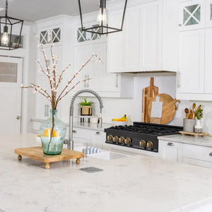 ZLINE Autograph Edition 36 in. Legacy Gas Rangetop with 6 Burners and Porcelain Cooktop in Black Stainless Steel with Champagne Bronze Accents (RTBZ-36-CB) lifestyle, in a luxury kitchen.