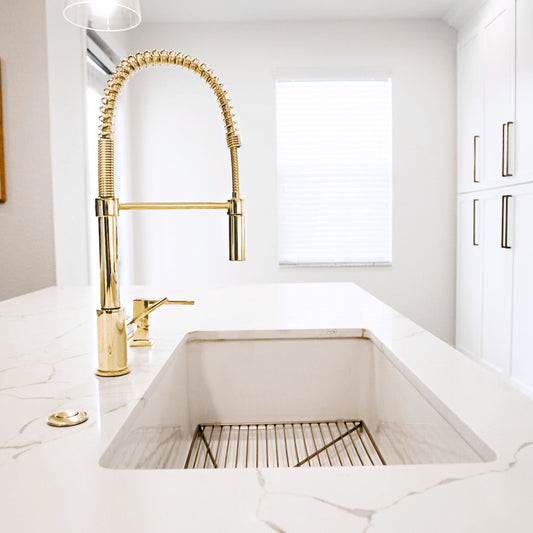 ZLINE Sierra Pull Down Spring Single Handle Kitchen Faucet in Polished Gold (SRA-KF-PG) in a white kitchen setting