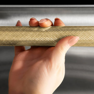 ZLINE Autograph Edition 24 in. Dishwasher Helix Handle (Set of 1) in Champagne Bronze (DWHZ-K-CB-24) on appliance showing diamond knurled details.