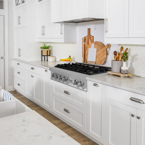 ZLINE 36 in. Legacy Gas Rangetop with 6 Burners and Porcelain Cooktop in Stainless Steel (RT36) in a farmhouse kitchen with white cabinets, marble countertops, and decorative elements.