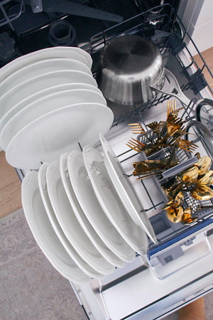 Open ZLINE 24 in. Tallac Series 3rd Rack Tall Tub Dishwasher in Custom Panel Ready with Stainless Steel Tub, 51dBa (DWV-24) with white plates, pots, and gold dinnerware.