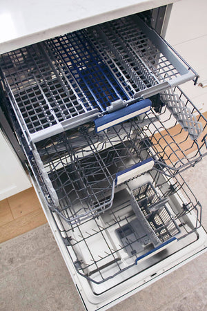 Open ZLINE 24 in. Tallac Series 3rd Rack Tall Tub Dishwasher in Custom Panel Ready with Stainless Steel Tub, 51dBa (DWV-24) with racks and compartments on a kitchen floor.
