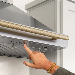 ZLINE Autograph Edition 36 in. Wall-Mount Range Hood Helix Handle (Set of 1) in Champagne Bronze (RHHZ-K-CB-36) installed in a designer kitchen.