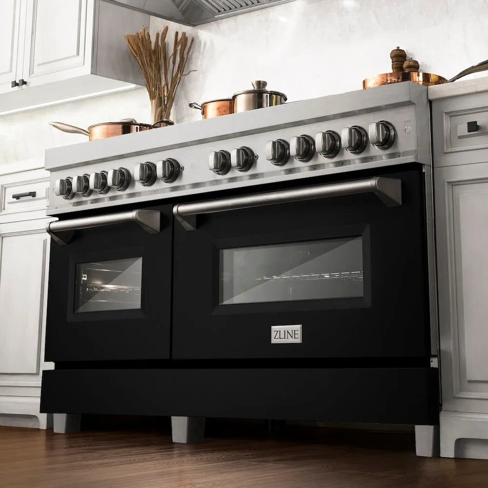 ZLINE 60 in. 7.4 cu. ft. Legacy Dual Fuel Range with 9 Burner Gas Cooktop and 2 Electric Convection Ovens in Satin Stainless Steel and Black Matte Doors (RAS-BLM-60) below, in a luxury farmhouse-style kitchen.