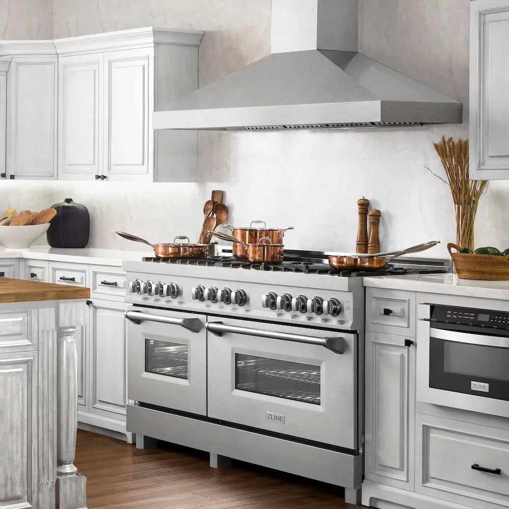 ZLINE 60 in. 7.4 cu. ft. Legacy Dual Fuel Range with Gas Cooktop and 2 Electric Convection Ovens in Satin Stainless Steel with 8 Brass Burners (RAS-SN-BR-60) side, in a luxury farmhouse-style kitchen.