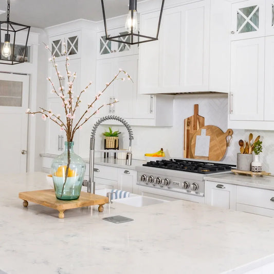 ZLINE 36 in. Legacy Gas Rangetop with 6 Brass Burners and Porcelain Cooktop in Stainless Steel (RT-BR-36) in a farmhouse kitchen with white cabinets, marble countertops, and decorative elements.